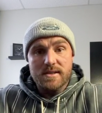 The Content Factory A person wearing a gray beanie and a striped hoodie is sitting indoors in an ATX podcast studio, looking at the camera. In Austin, Texas